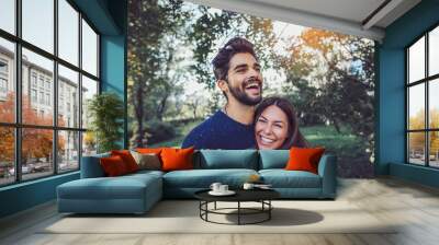 Young couple in love having fun and enjoying the beautiful nature Wall mural