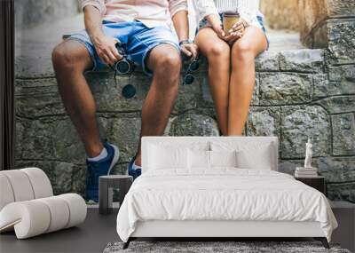 young couple in love traveling, old city center, legs close up Wall mural