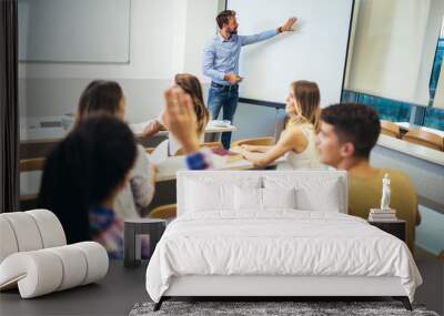 Young students listening to professor in the classroom on college Wall mural