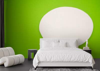 a blank white speech bubble over a light green background Wall mural