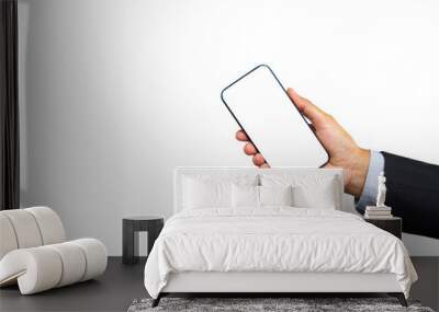 Businessman holding a white blank screen smartphone vertically while standing on a transparent background. Wall mural