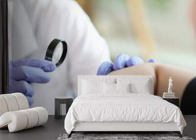 Female doctor examining male patient skin at consultation in medical clinic Wall mural