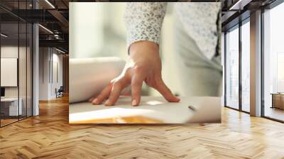 Female engineer unrolls large paper with building drawing Wall mural