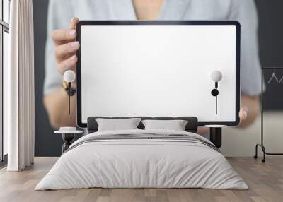 Female hands hold tablet with white screen Wall mural