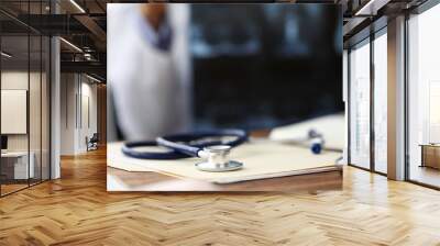 Medical stethoscope head lying at paper document on table Wall mural