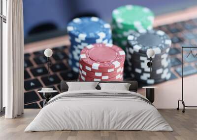 On laptop keyboard are colorful casino chips Wall mural