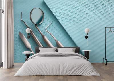 Pile of dentist tools lying at green tissue Wall mural