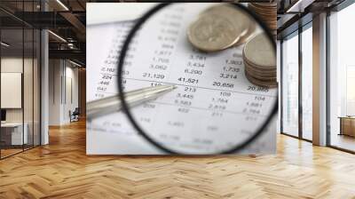 View at financial details in table thru magnifying glass Wall mural