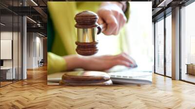 Woman hand striking with judge gavel in court room Wall mural