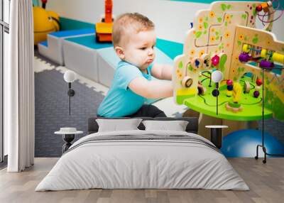 Baby Playing with Wooden Puzzle Wall mural