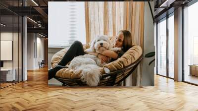 Girl with her dog at home Wall mural