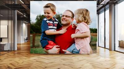 Happy Father holding sons Wall mural