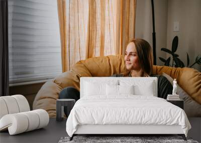 Woman relaxing at home with mug Wall mural