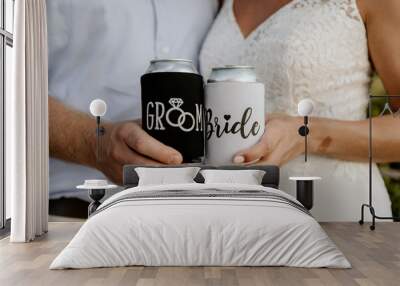 Bride and Groom Holding Matching Mr. and Mrs. Can Koozies On Their Wedding Day Wall mural