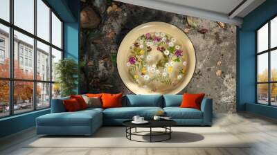 Flowers and herbs floating in a bowl on a natural background. Beautiful garden scene Wall mural