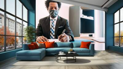 Afro Businessman working at office. Wall mural