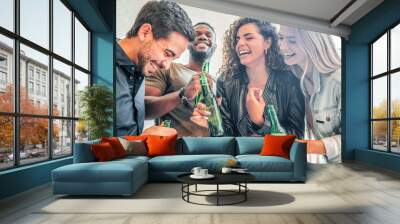 Friends having fun while drinking beer together. Wall mural