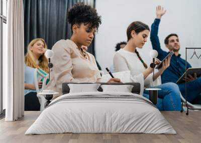 Group of young people sitting on conference together. Wall mural