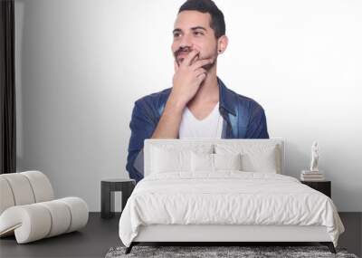 Portrait of young latin thoughtful man. Wall mural