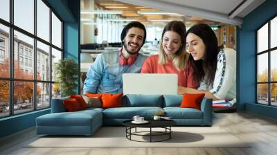 University students using laptop in university library. Wall mural