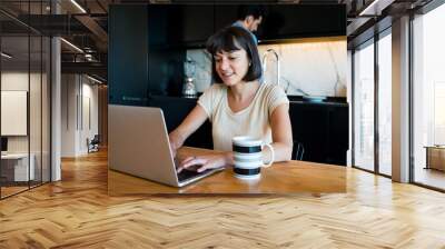 Young woman working from home. Wall mural