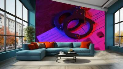 Applicant or fingerprints card with police handcuffs on table in dark room close up Wall mural