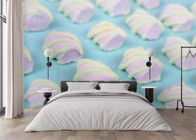 Colorful marshmallow laid out on blue paper background. pastel creative textured pattern. Perspective macro shot Wall mural