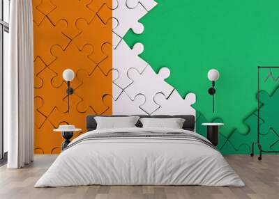 Ivory Coast flag  is depicted on a completed jigsaw puzzle with free green copy space on the right side Wall mural