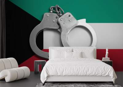 Kuwait flag  and police handcuffs. The concept of observance of the law in the country and protection from crime Wall mural