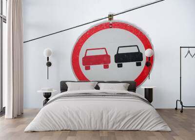 Road sign. Overtaking is prohibited. The sign prohibits overtaking all vehicles on the road section. A red and black car is depicted in a framed red circle Wall mural