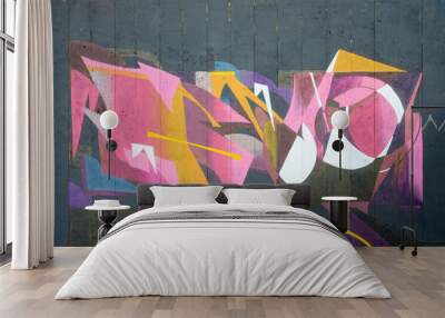 The old wall decorated with paint stains in the style of street art culture. Colorful background of full graffiti painting artwork with bright aerosol outlines on wall. Colored background texture Wall mural