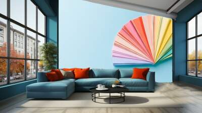 paper color swatches arranged in fan shape on light blue background Wall mural