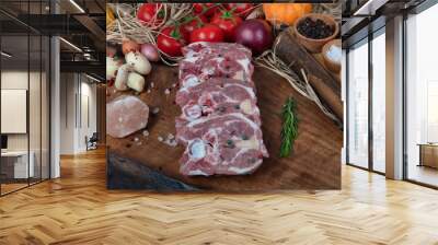 Overhead view of chopped fresh lamb shank, lamb neck  on cutting board with spice Wall mural