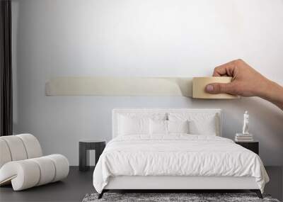 Paper masking tape. Masking tape on white. Man hands with masking tape isolated on white background. Wall mural