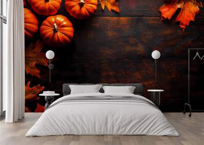 Autumn background with pumpkins and fall leaves on a dark wood table for Halloween or casual party decoration, Wall mural