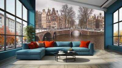 Winter snow view of Dutch canal and old houses in the historic city of Amsterdam, the Netherlands Wall mural