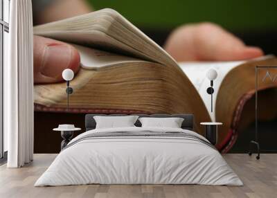 young man reading small bible Wall mural