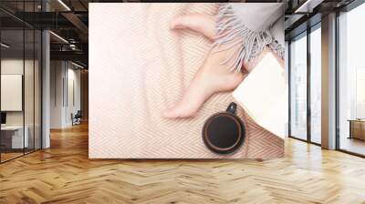 Cozy woman with book and cup of coffee on wooden blanket Wall mural