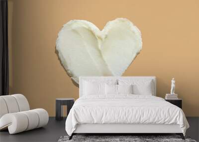 Heart shape shea butter cream texture smudge stroke on beige brown color background Wall mural