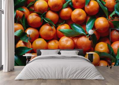 Fresh tangerines with stems and leaves, for sale at market. Wall mural