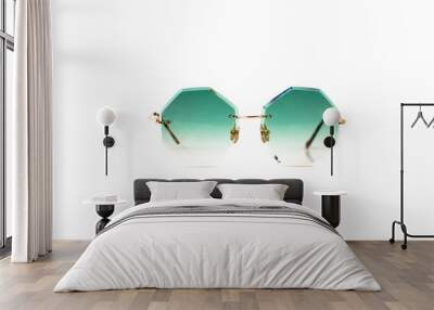 Green octagonal shaped gradient sunglasses with gold metal frame isolated on white background, front view. Wall mural