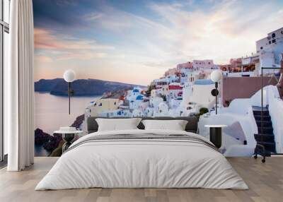 beautiful Oia town on Santorini island, Greece. Traditional white architecture and greek orthodox churches with blue domes over the Caldera, Aegean sea. Scenic travel background Wall mural