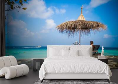 couple relaxing on tropical beach chairs Wall mural