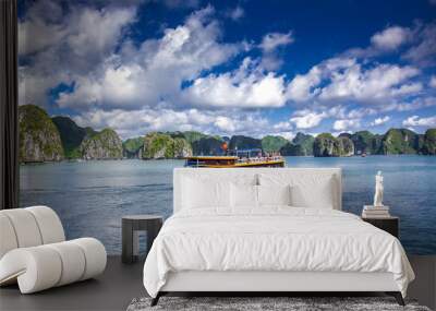 cruising among beautiful limestone rocks and secluded beaches in ha long bay, unesco world heritage  Wall mural