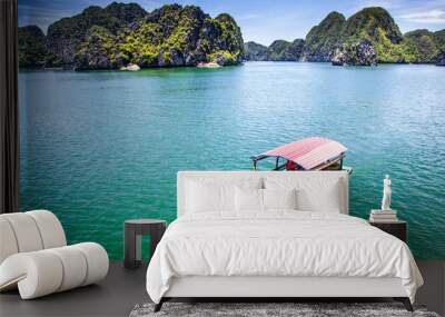 cruising among beautiful limestone rocks and secluded beaches in Ha Long bay, UNESCO world heritage site, Vietnam Wall mural