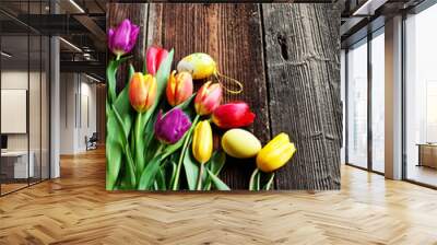 Easter eggs and fresh spring tulips on weathered wooden backgrou Wall mural