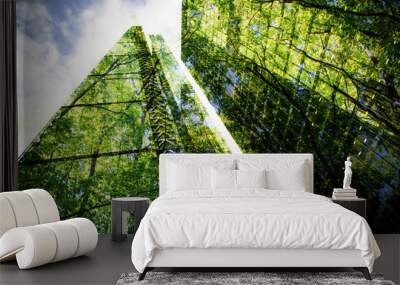 green city - double exposure of lush green forest and modern skyscrapers windows. Wall mural