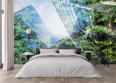 green city - double exposure of lush green forest and modern skyscrapers windows Wall mural