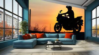 man on his motorbike riding into sunset Wall mural