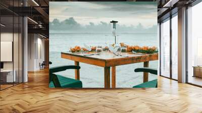 romantic dinner table setting on sunset beach Wall mural